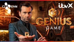 David Tennant in a dark suit stares intently while holding a gold cube in front of the Genius Game logo. The background features a futuristic game set with glowing orange and bronze tones. ITVX and CJ ENM logos are visible.